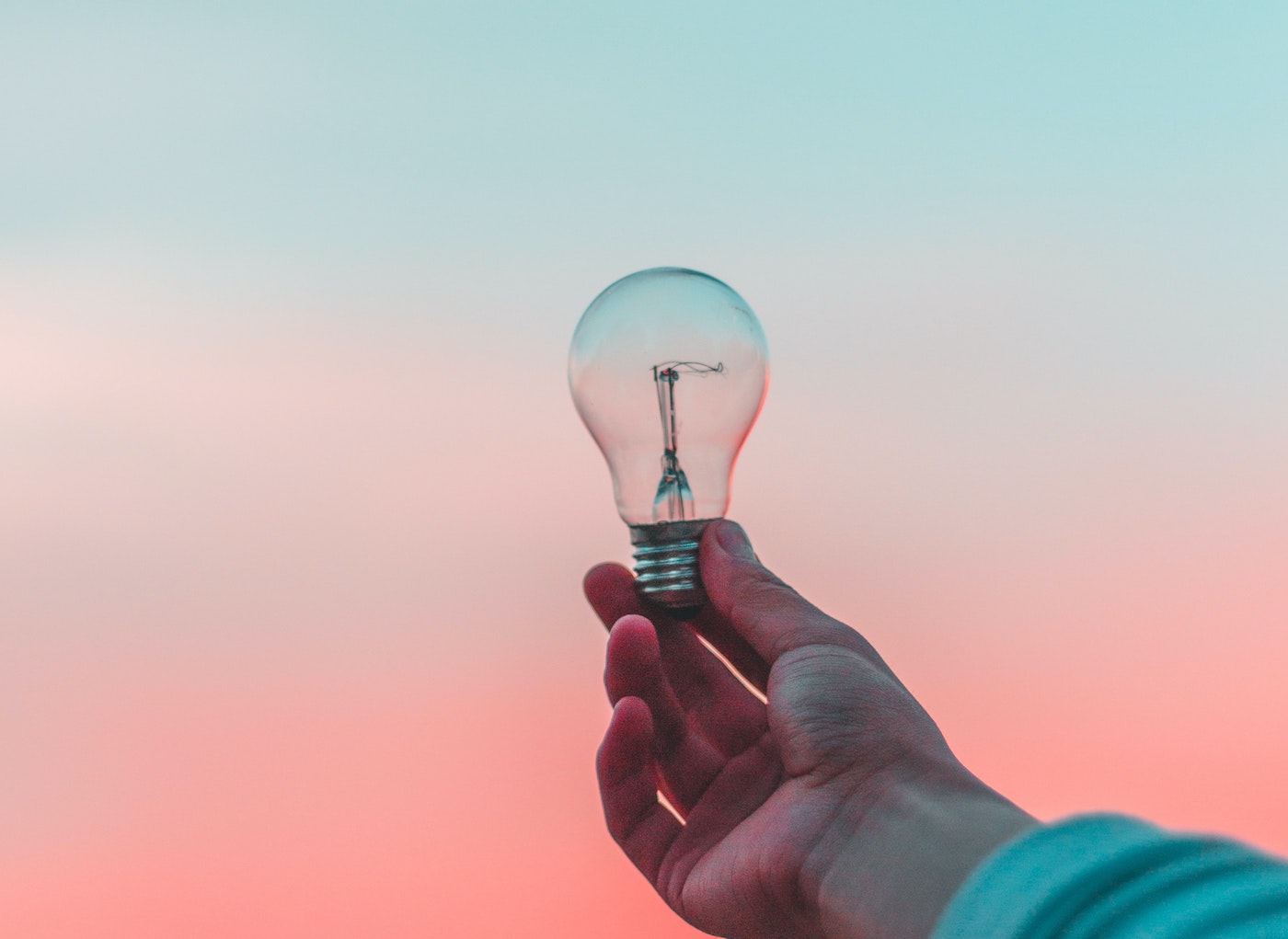 Person holding up a lightbulb