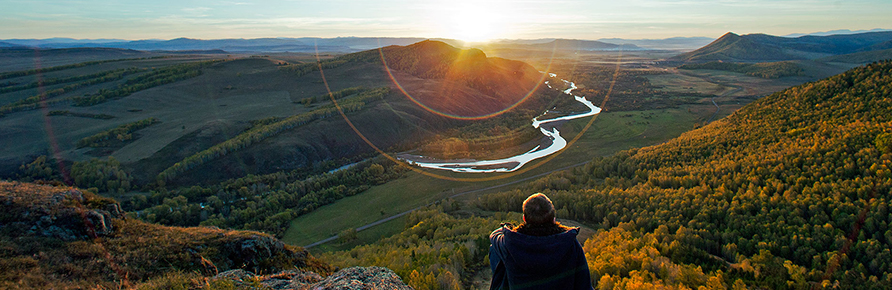 Person looking down at the view of the mountains and nature