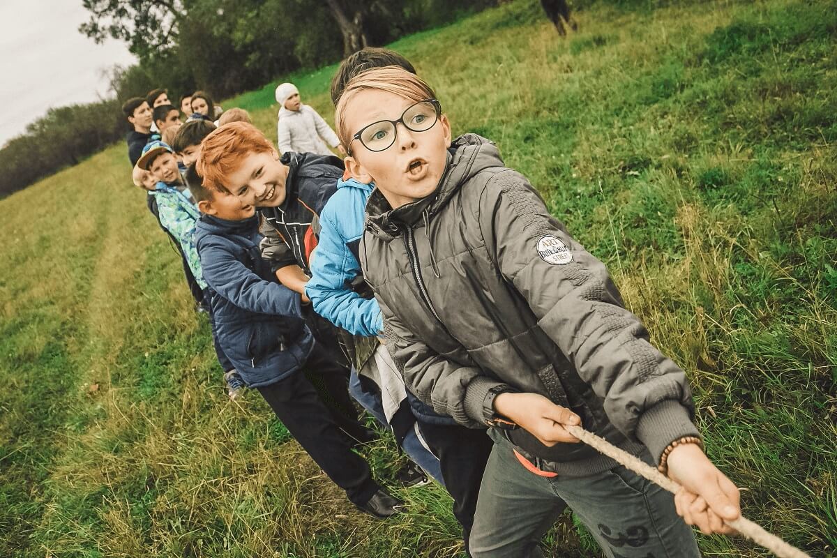 children playing tug of war with rope