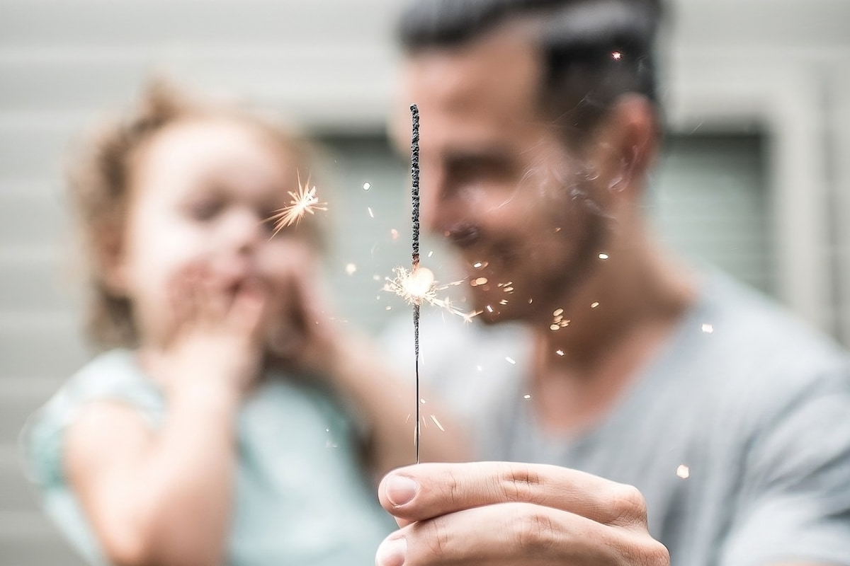 father and daughter holding a sprinkler