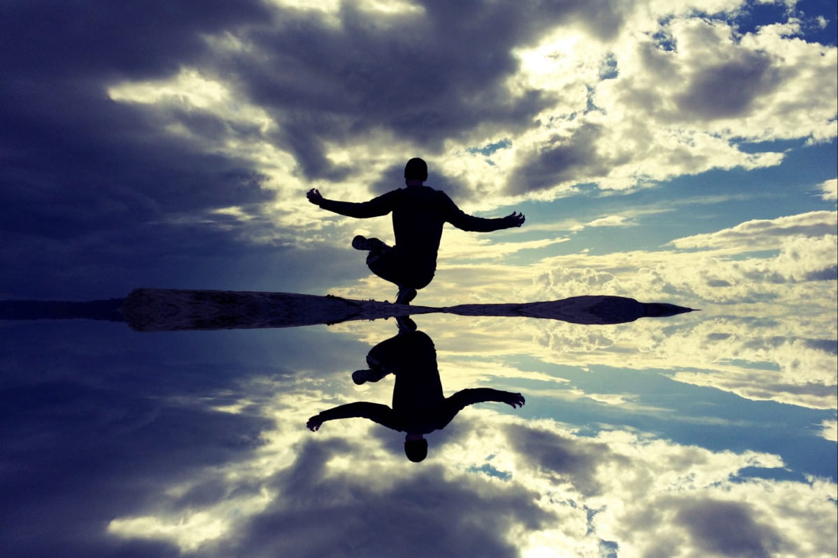 Man mediating by clear water