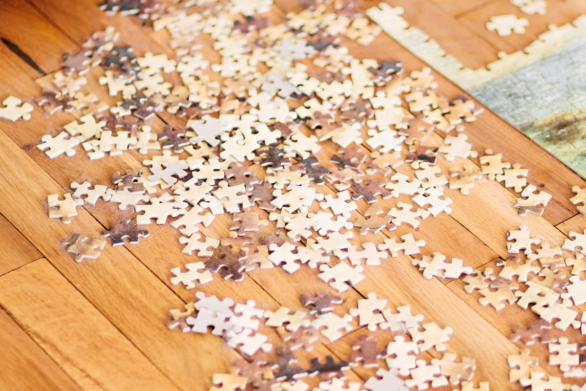 puzzle pieces scattered on wooden floor