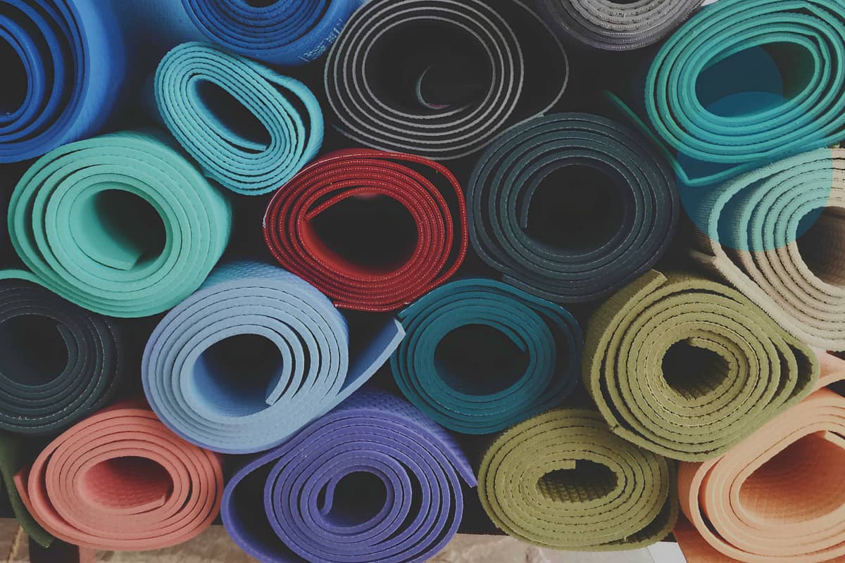 stack of colorful yoga mats