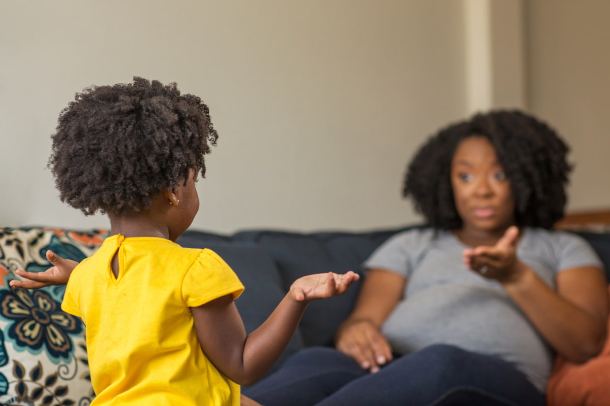 African American mother talking with her daughter.