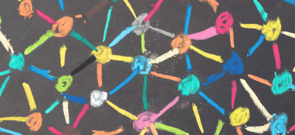 Colorful drawing of dots connected to each other on chalk board