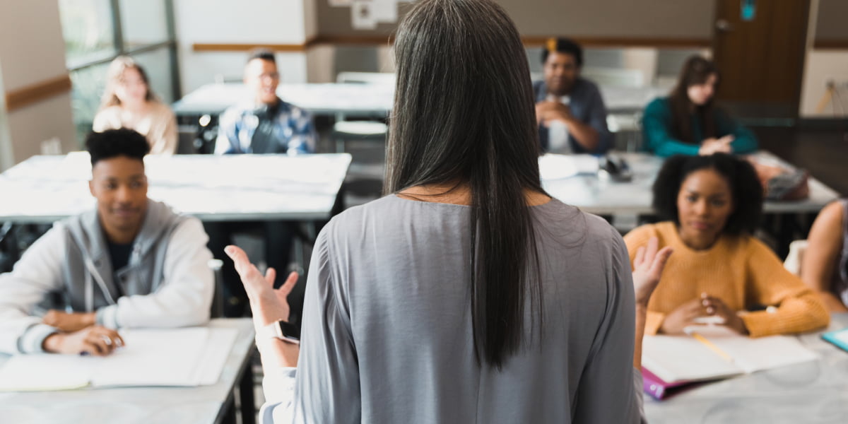 Back view of female teacher teaching middle school class